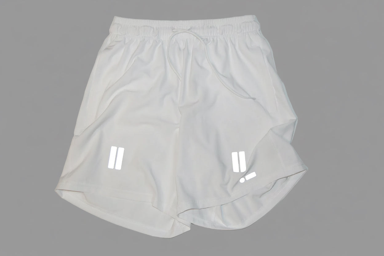 White athletic shorts with drawstring on a light gray background