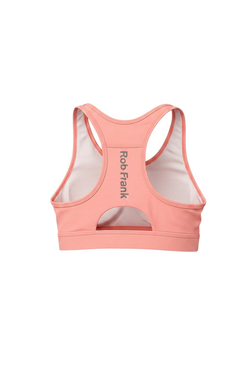Robfrank.com coral pink racerback sports bra with moisture-wicking fabric, reflective logo, and cutout back detail.